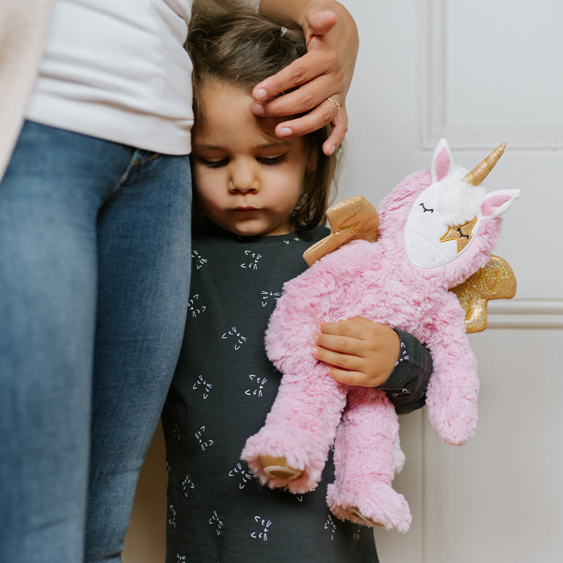 Caregiver with child holding Unicorn Pegasus Kin