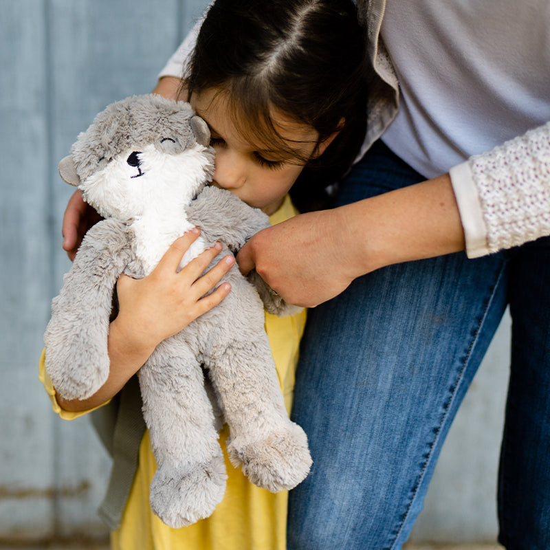 Child holding Otter Kin to soothe school related anxiety. 