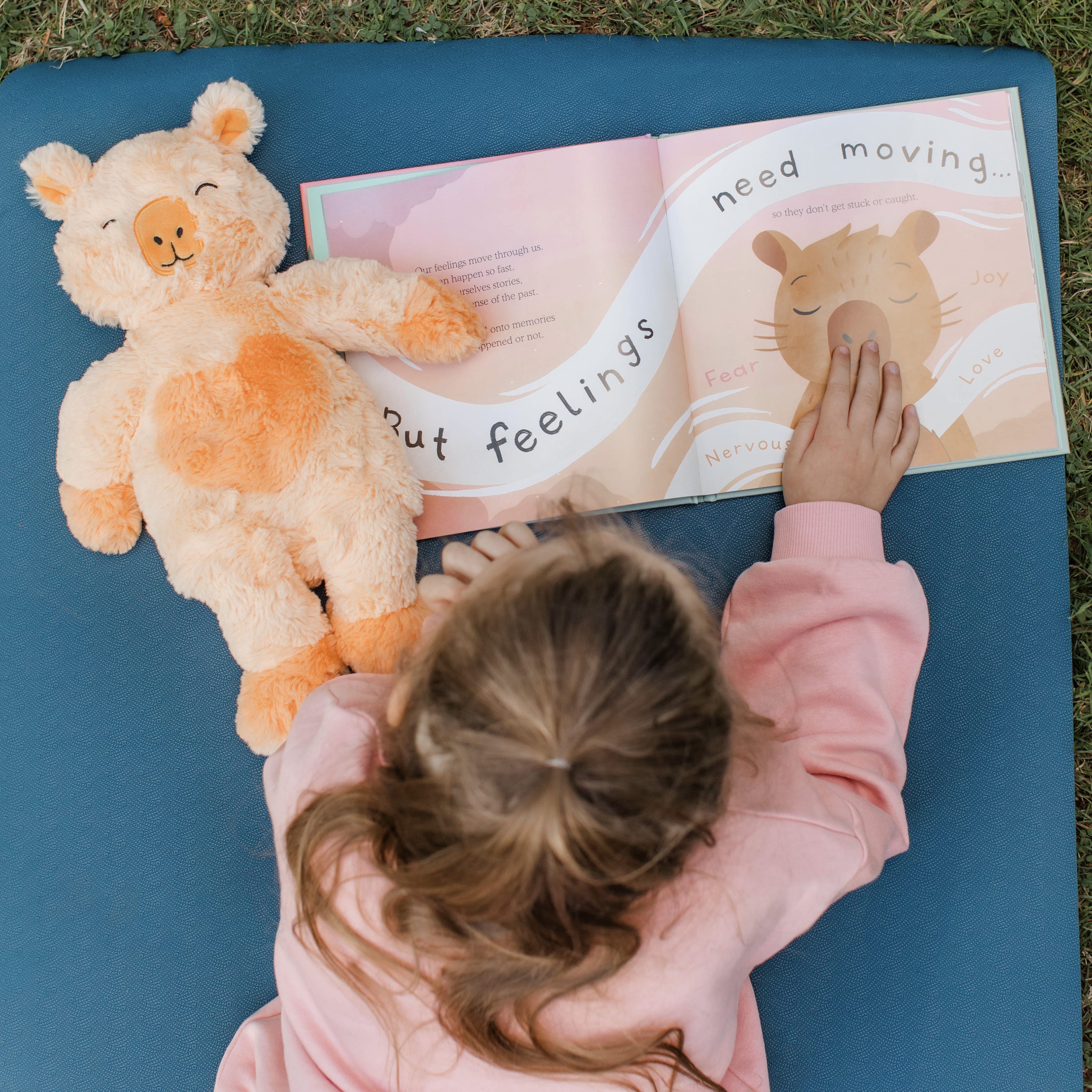 A child holding Slumberkins plush creatures