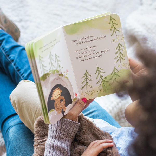A caregiver and child reading a Bigfoot Board Book