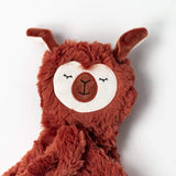 Closeup of Alpaca Snuggler's face. Highlighting the eyes, ears and cozy fabric.