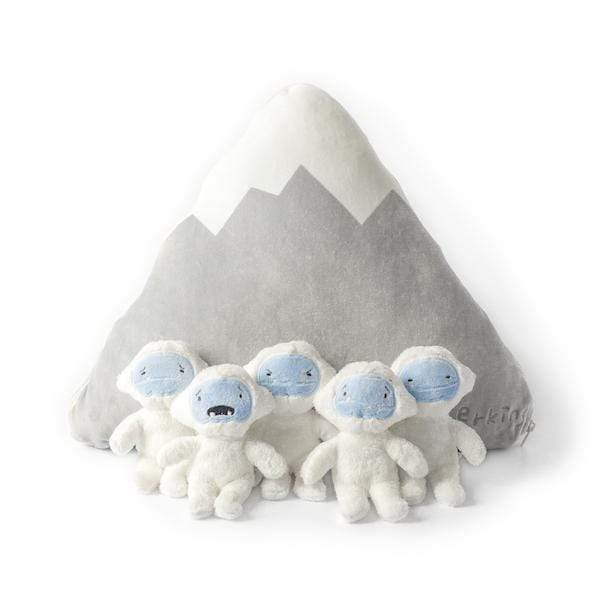 All 5 mini Yetis sitting in front of the Zip-up mountain pilow - View Product